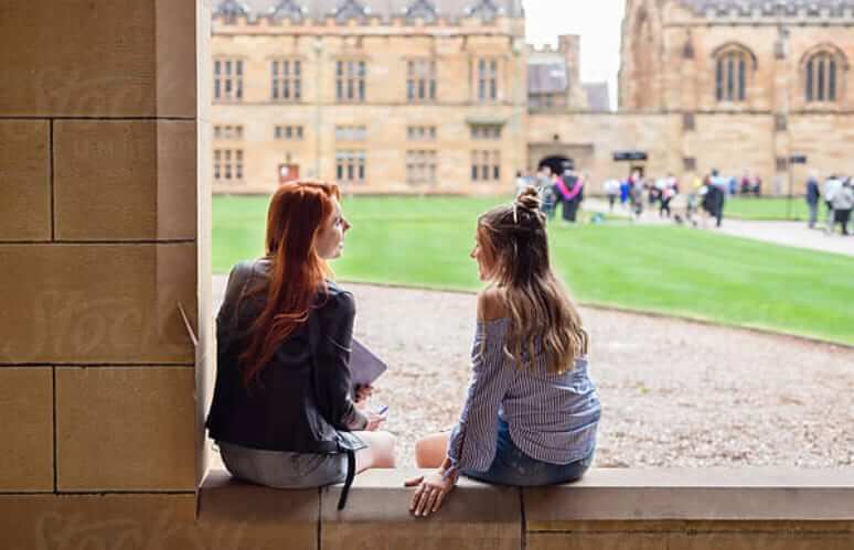 students chatting in front of their university