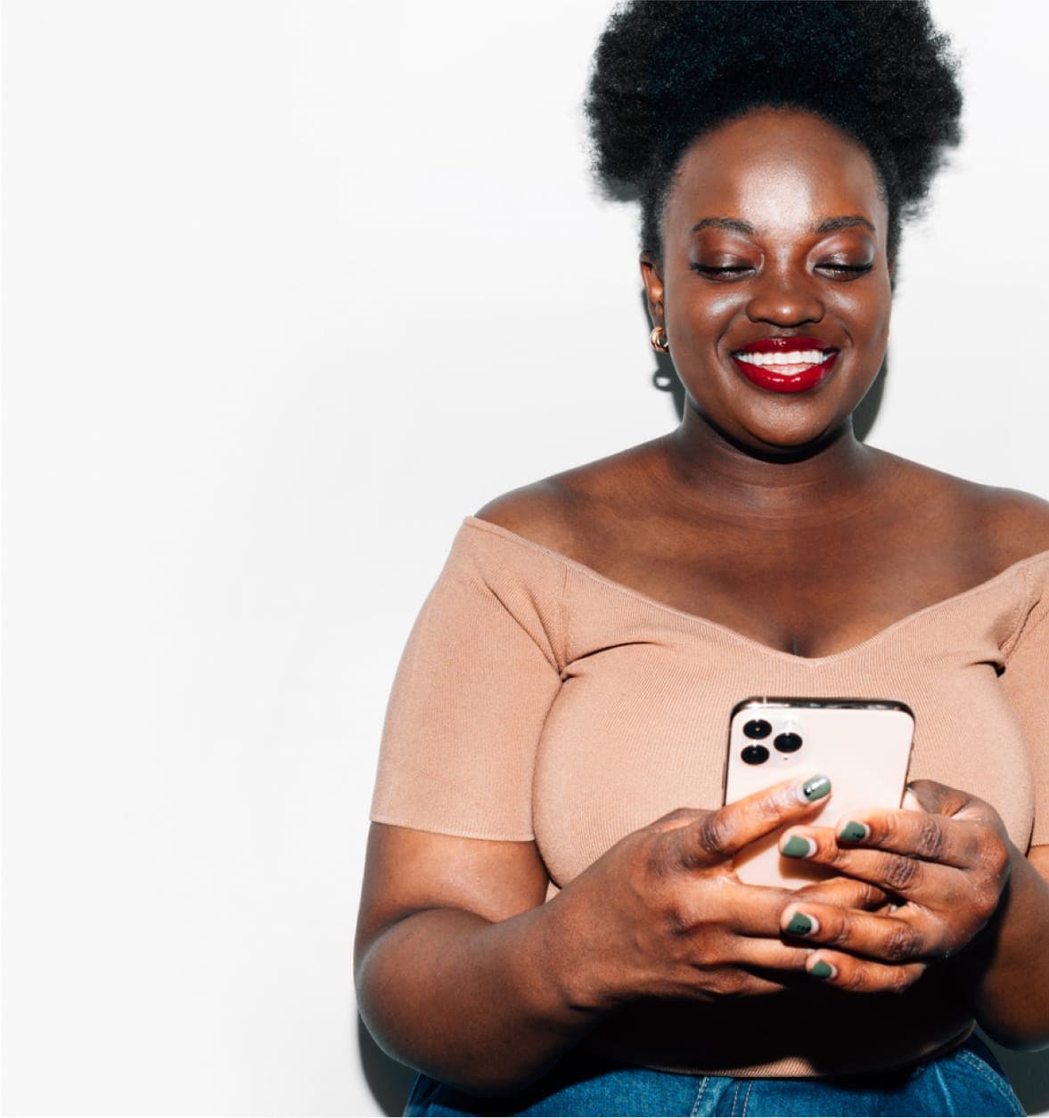 Unibuddy sample student message overlayed on smiling woman wearing light brown shirt interacting with white phone