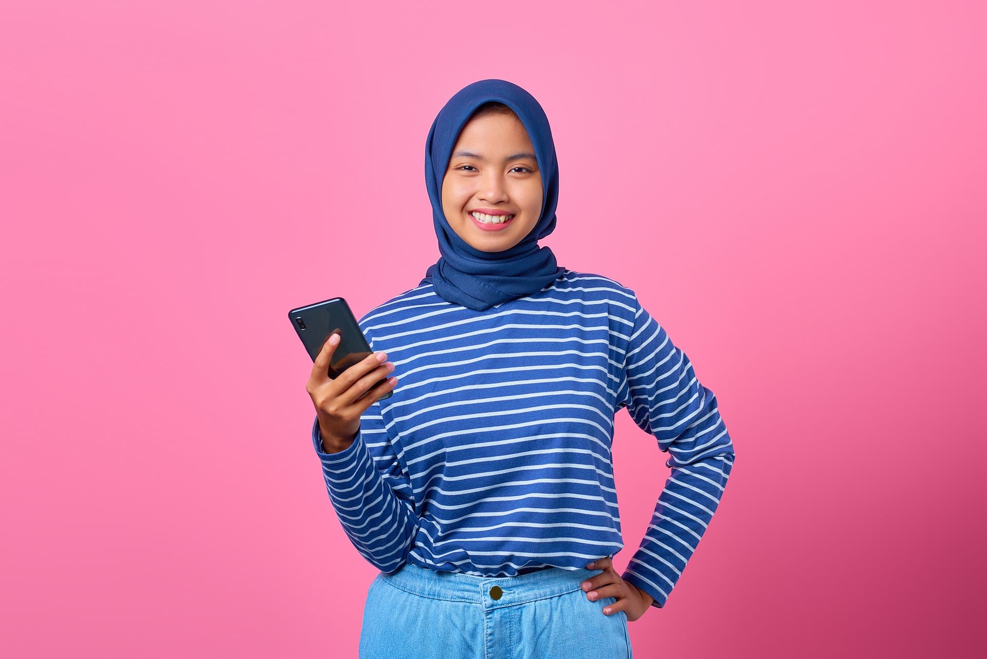 woman smiling holding phone