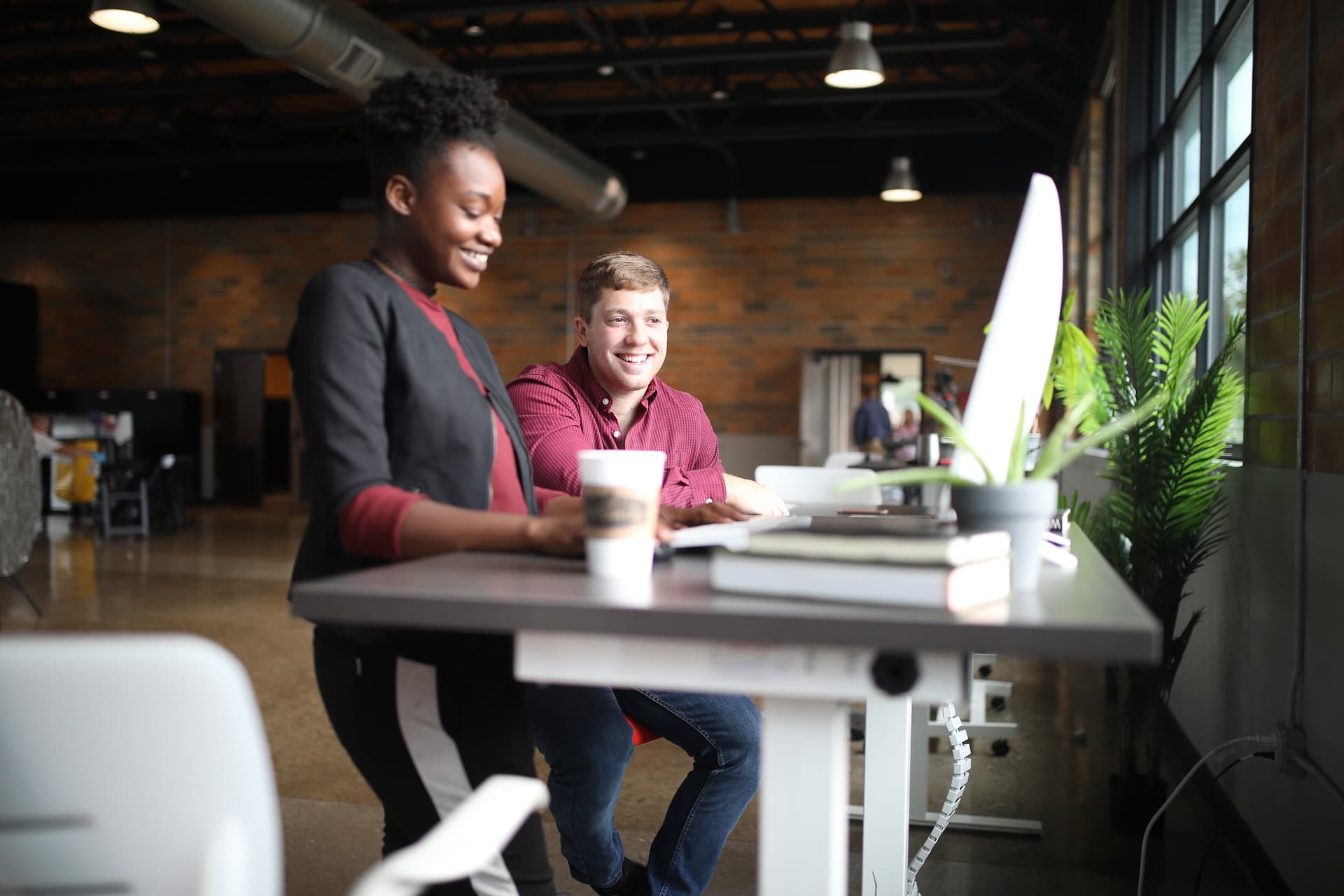 two people working together off computer