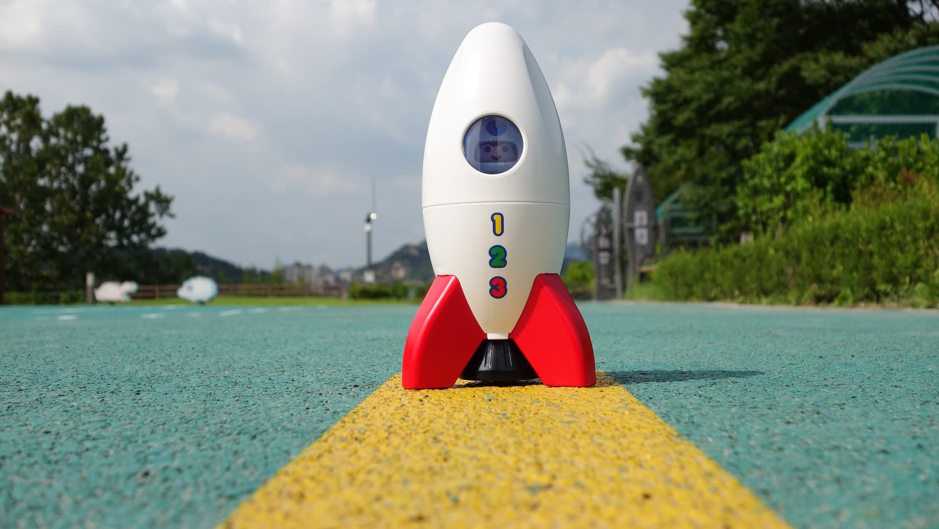 toy rocket standing on concrete outdoors