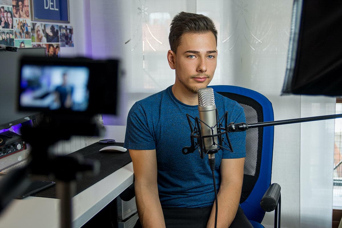 man sitting in studio on-camera in front of mic