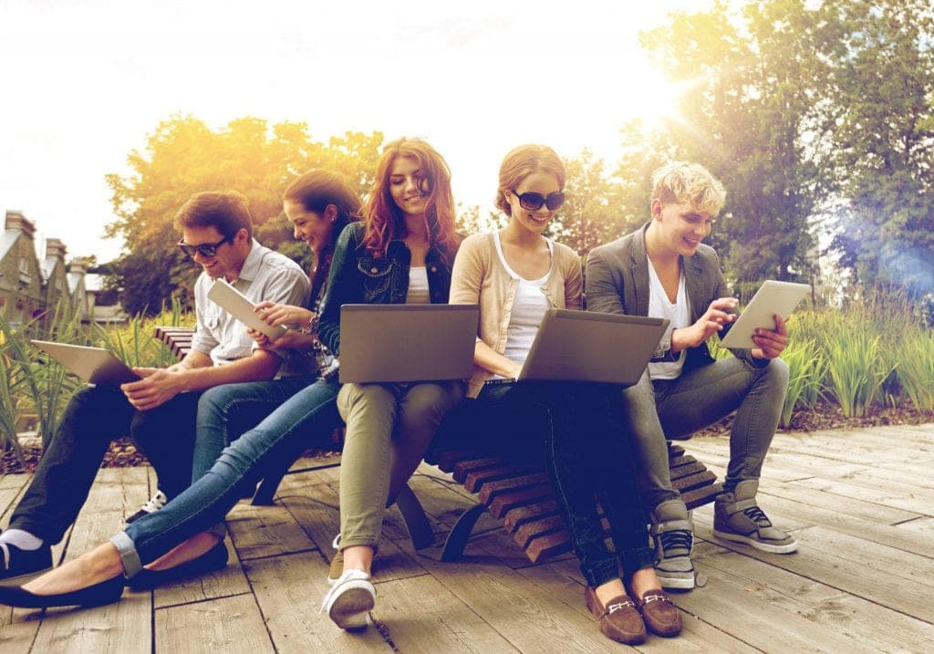 Students on laptops outside