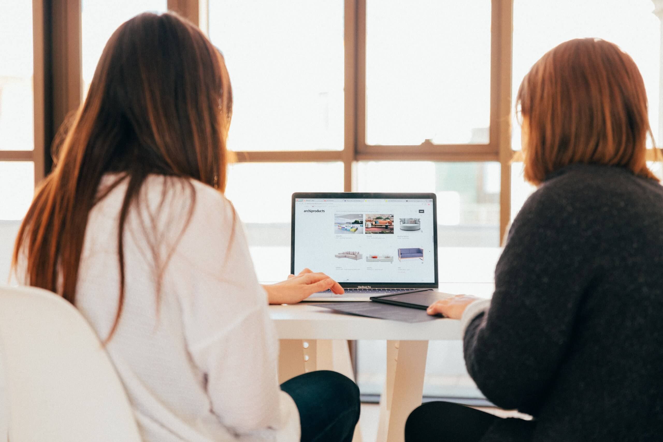 Two women looking at the laptop screen