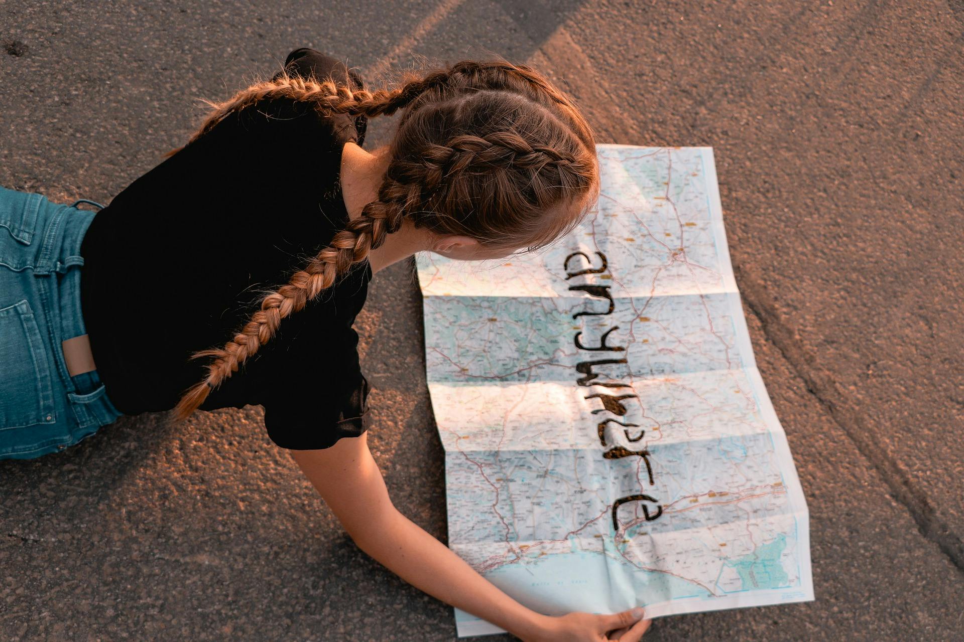 girl reading map that reads "anywhere"